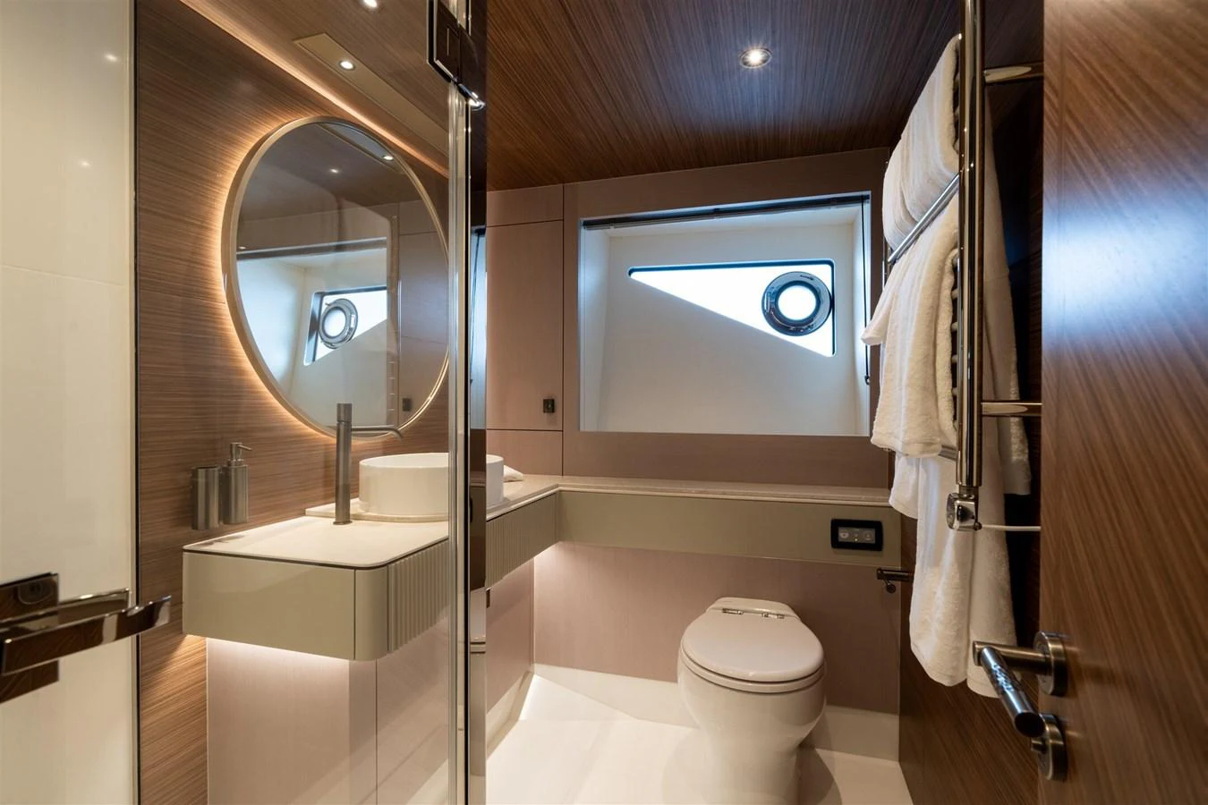 A modern yacht bathroom featuring sleek design and high-end fixtures. aboard 82 OCEAN ENCLOSED Yacht for Sale
