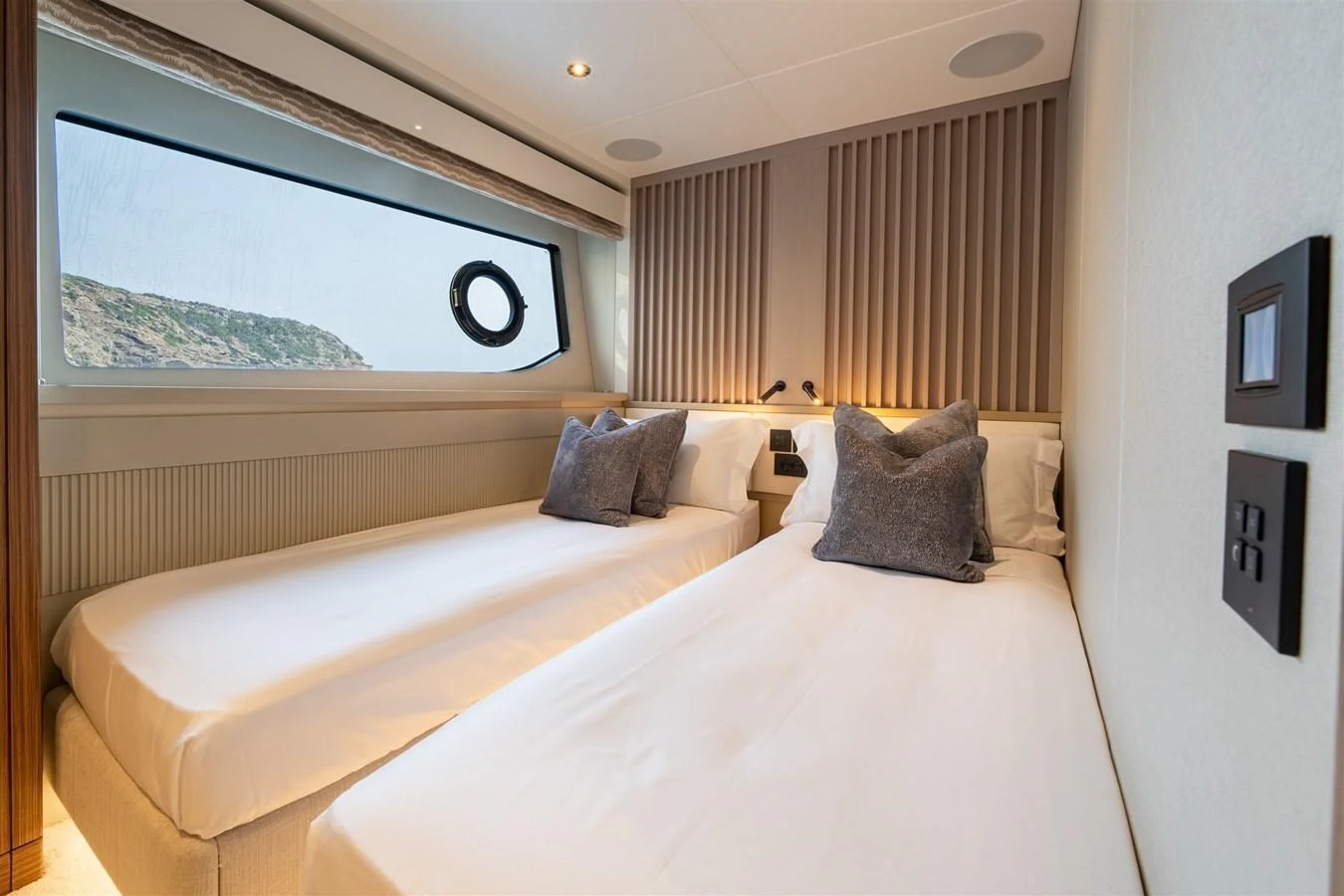 The twin stateroom features two comfortable single beds with a large window providing natural light and scenic views. aboard 82 OCEAN ENCLOSED Yacht for Sale
