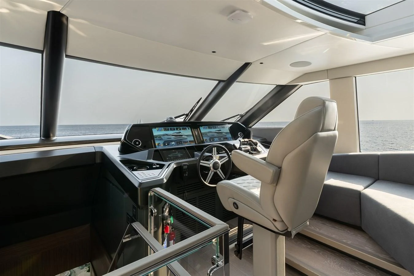 The helm station features state-of-the-art navigation equipment and a comfortable captain's chair with panoramic views. aboard 82 OCEAN ENCLOSED Yacht for Sale