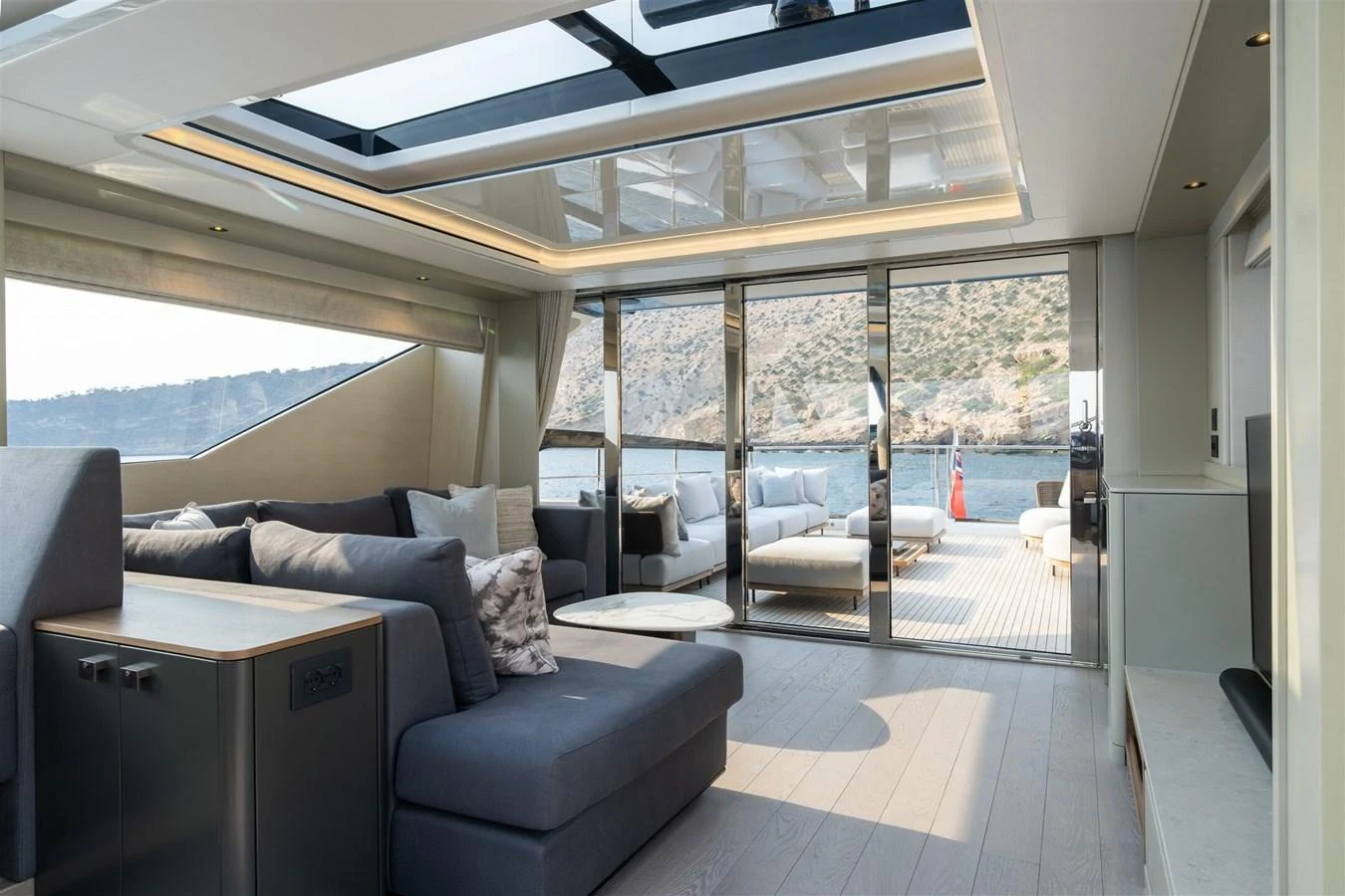 The salon features a spacious and modern design with ample natural light and comfortable seating. aboard 82 OCEAN ENCLOSED Yacht for Sale