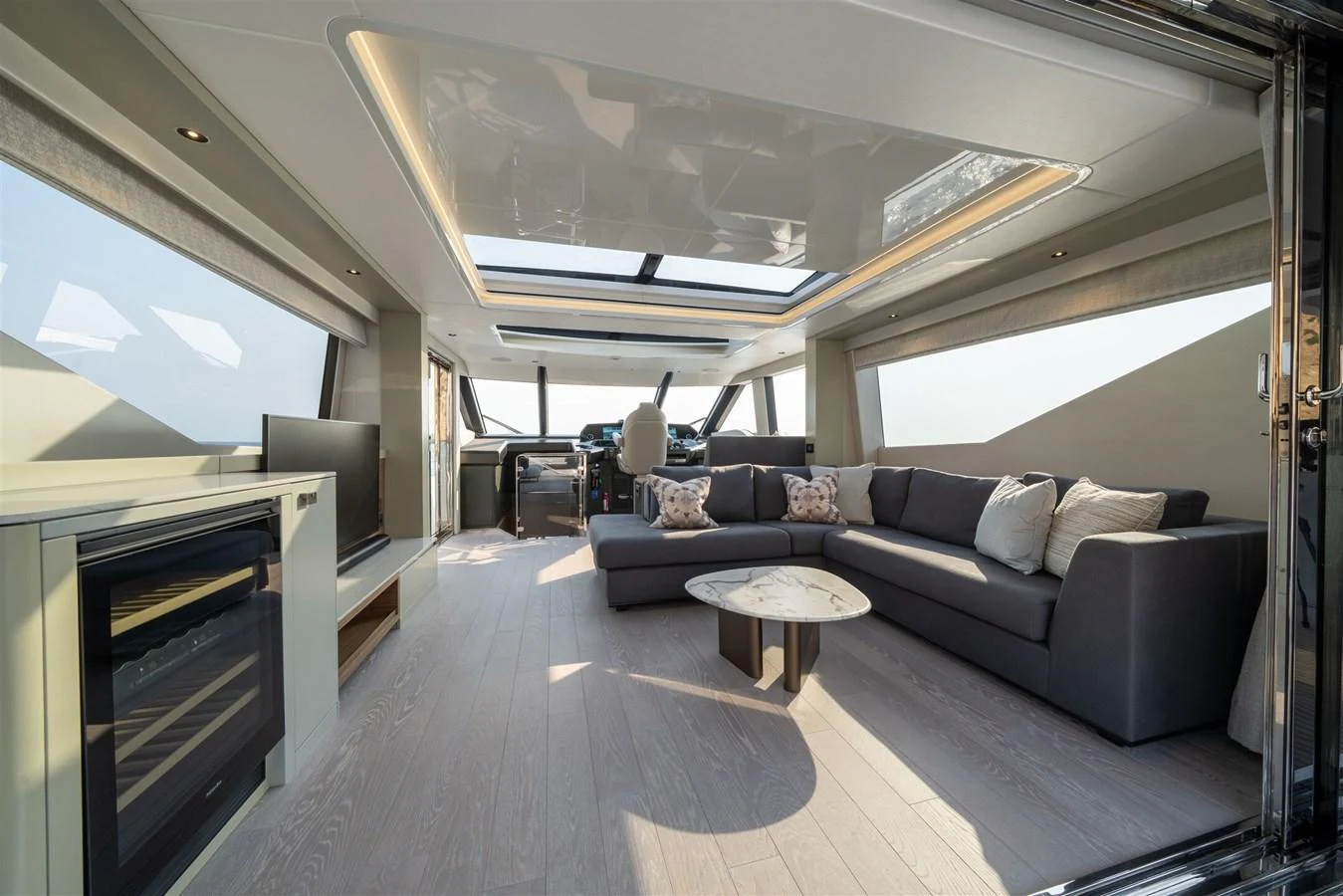 The salon offers a spacious and modern living area with ample natural light and luxurious furnishings. aboard 82 OCEAN ENCLOSED Yacht for Sale
