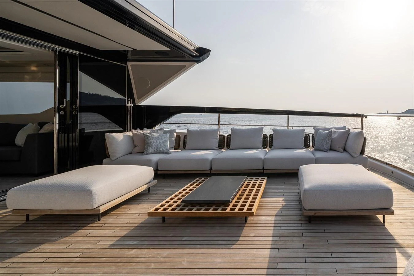 The aft deck features a spacious and stylish lounging area with plush seating and a modern coffee table, perfect for relaxation while enjoying the sea view. aboard 82 OCEAN ENCLOSED Yacht for Sale