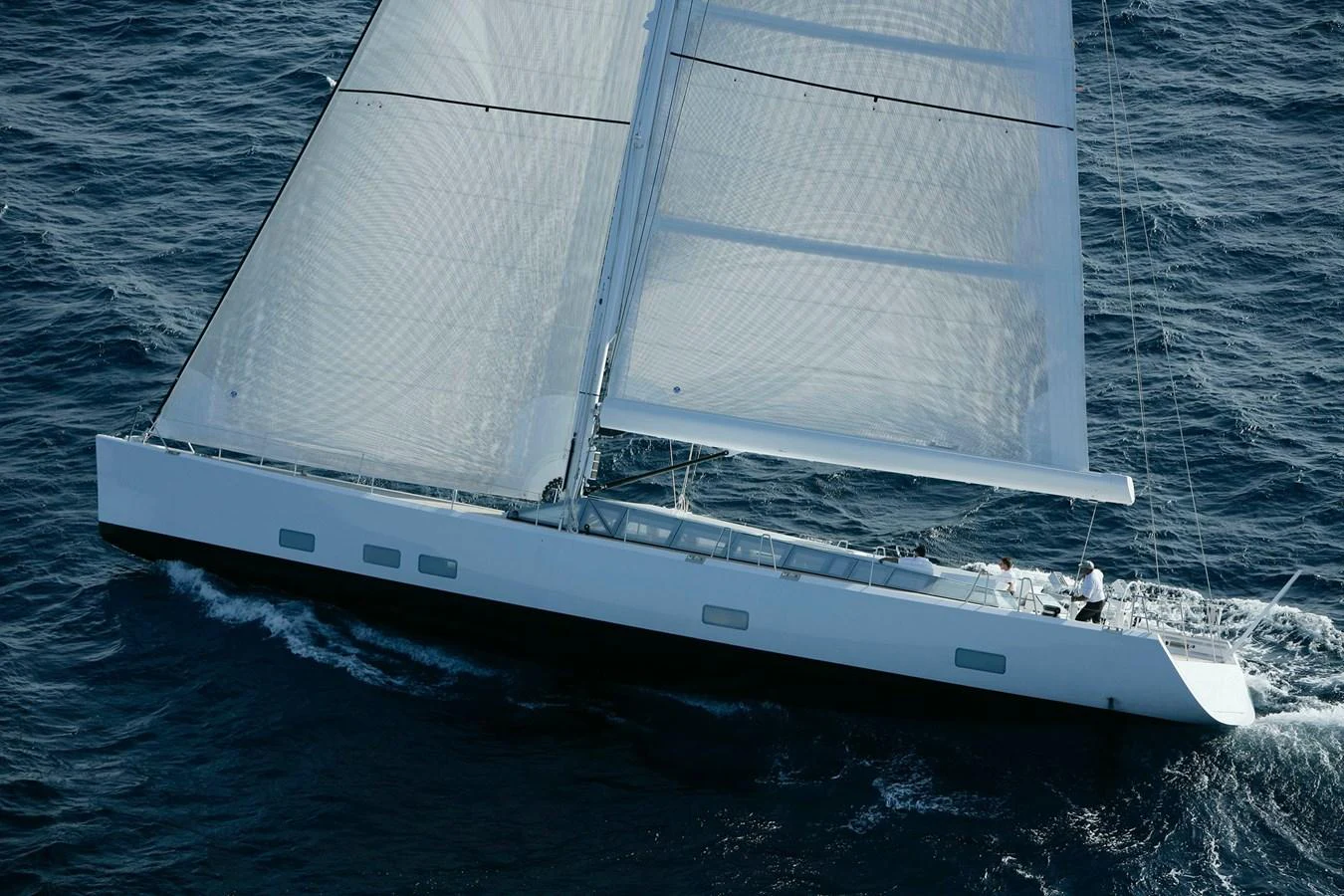 A sleek sailing yacht glides gracefully over the water, showcasing its impressive sails and streamlined design. aboard POLYTROPON II Yacht for Sale
