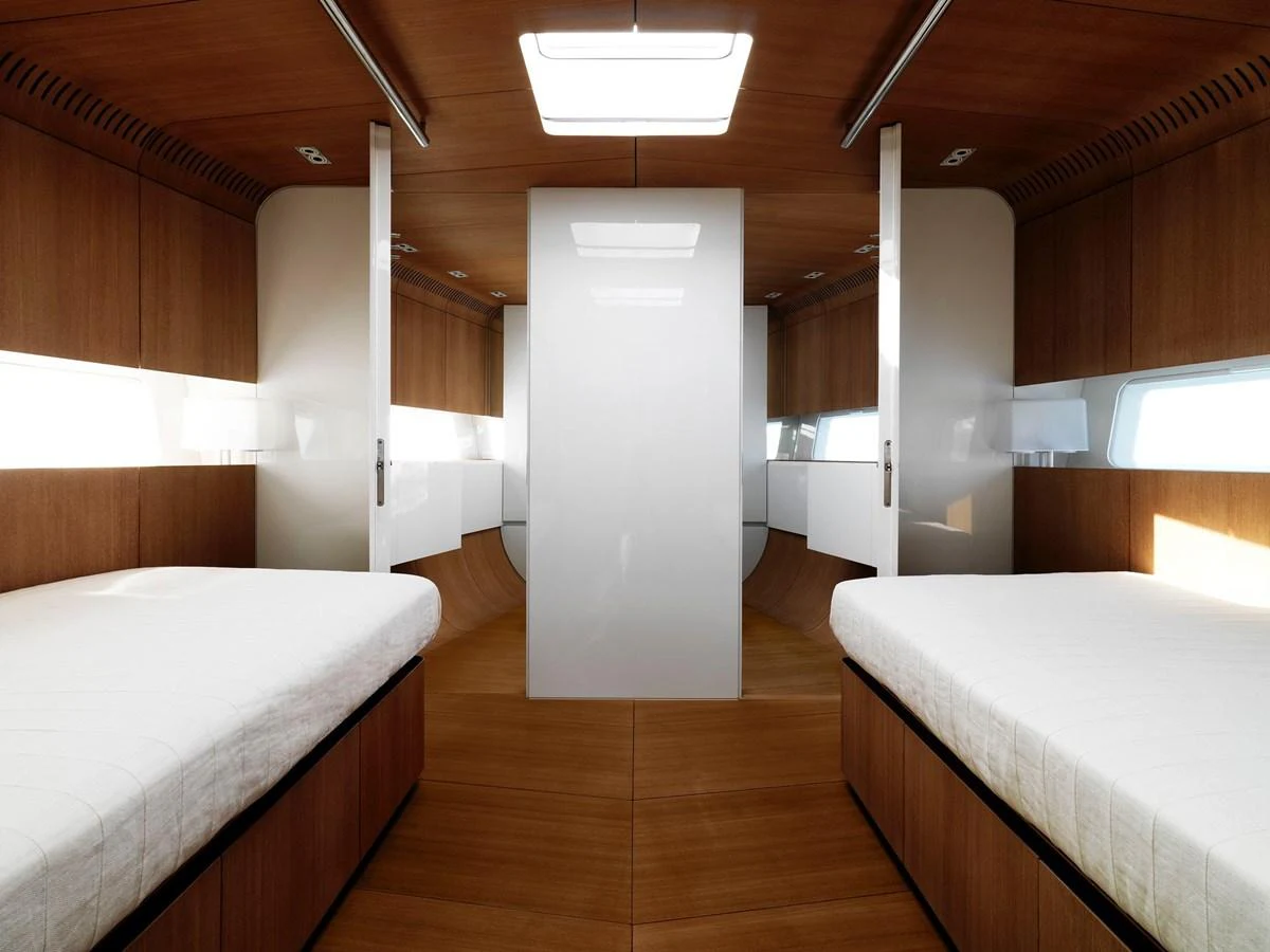 The stateroom features twin beds with sleek, modern wood paneling and ample natural light. aboard POLYTROPON II Yacht for Sale
