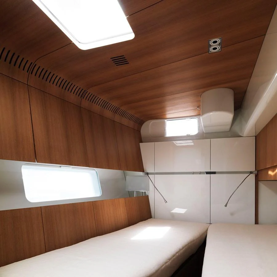 The cozy cabin features sleek wooden paneling and modern lighting, creating a warm and inviting atmosphere. aboard POLYTROPON II Yacht for Sale