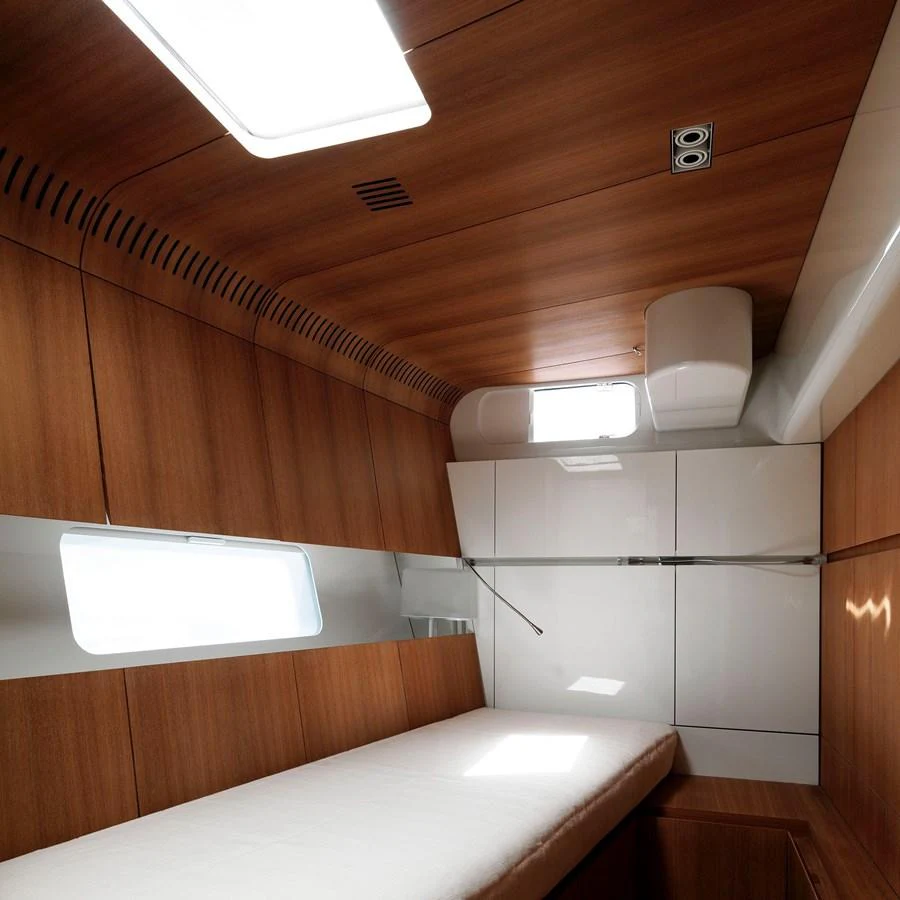 A cozy cabin with wooden paneling and a single bed. aboard POLYTROPON II Yacht for Sale