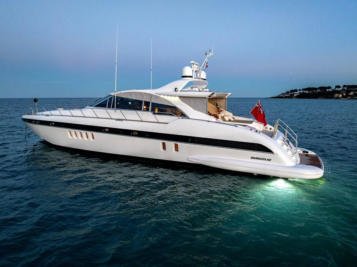 A sleek, modern yacht cruises gracefully on calm waters at dusk. aboard K GRACE Yacht for Sale