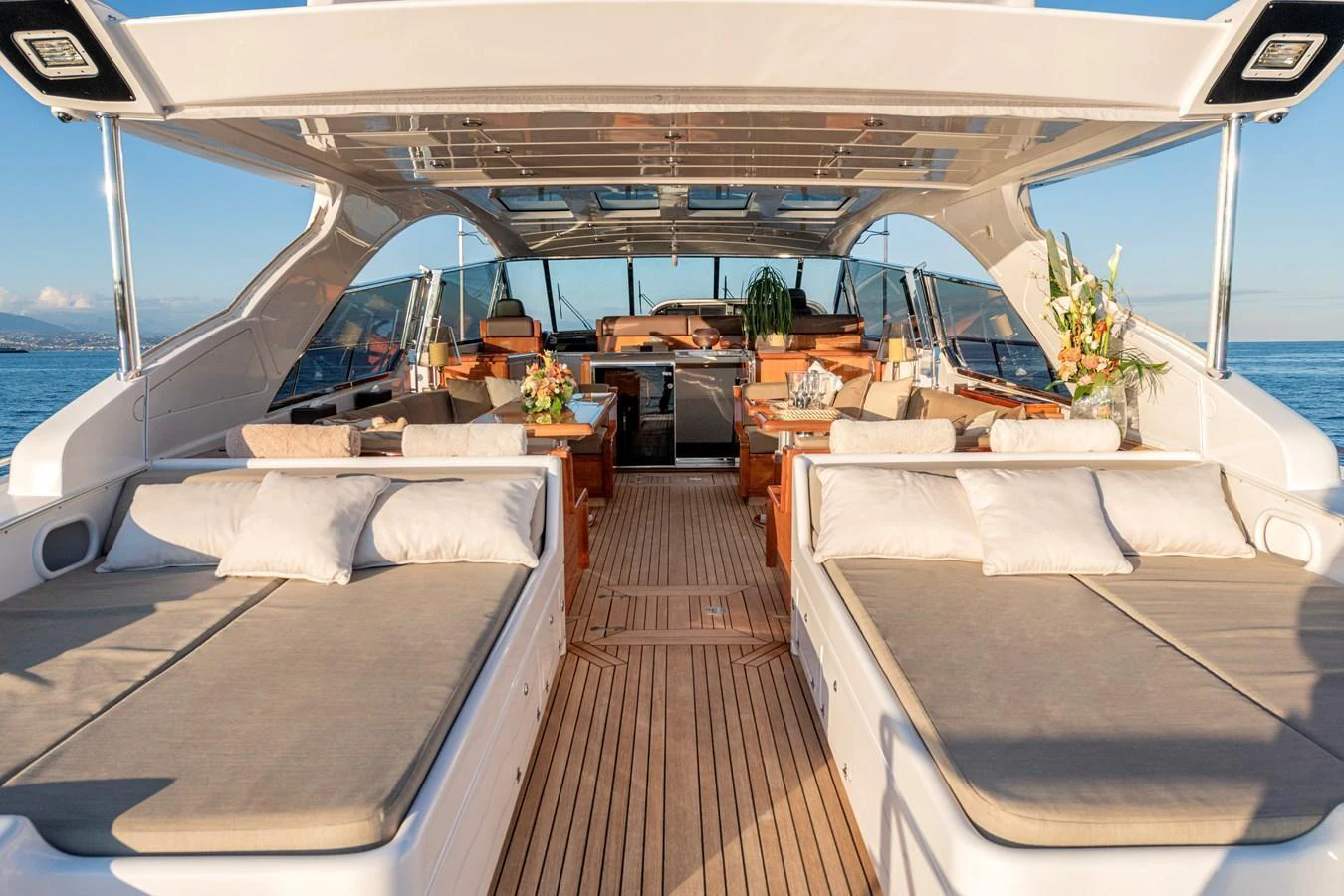 The aft deck features spacious sun loungers and a stylish seating area under a sleek canopy. aboard K GRACE Yacht for Sale