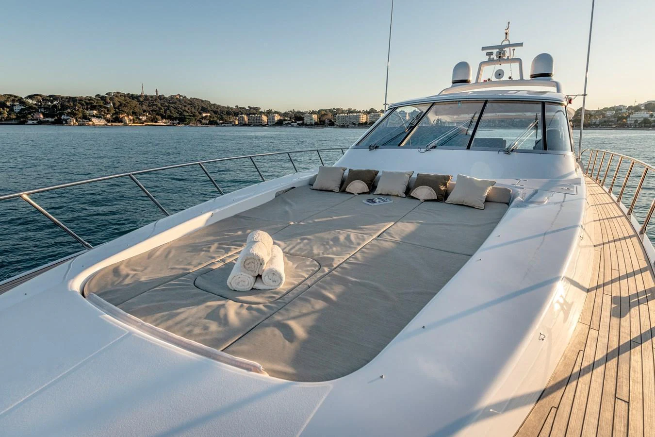 The yacht's foredeck features a spacious sunbathing area with plush cushions and rolled towels, perfect for relaxation. aboard K GRACE Yacht for Sale