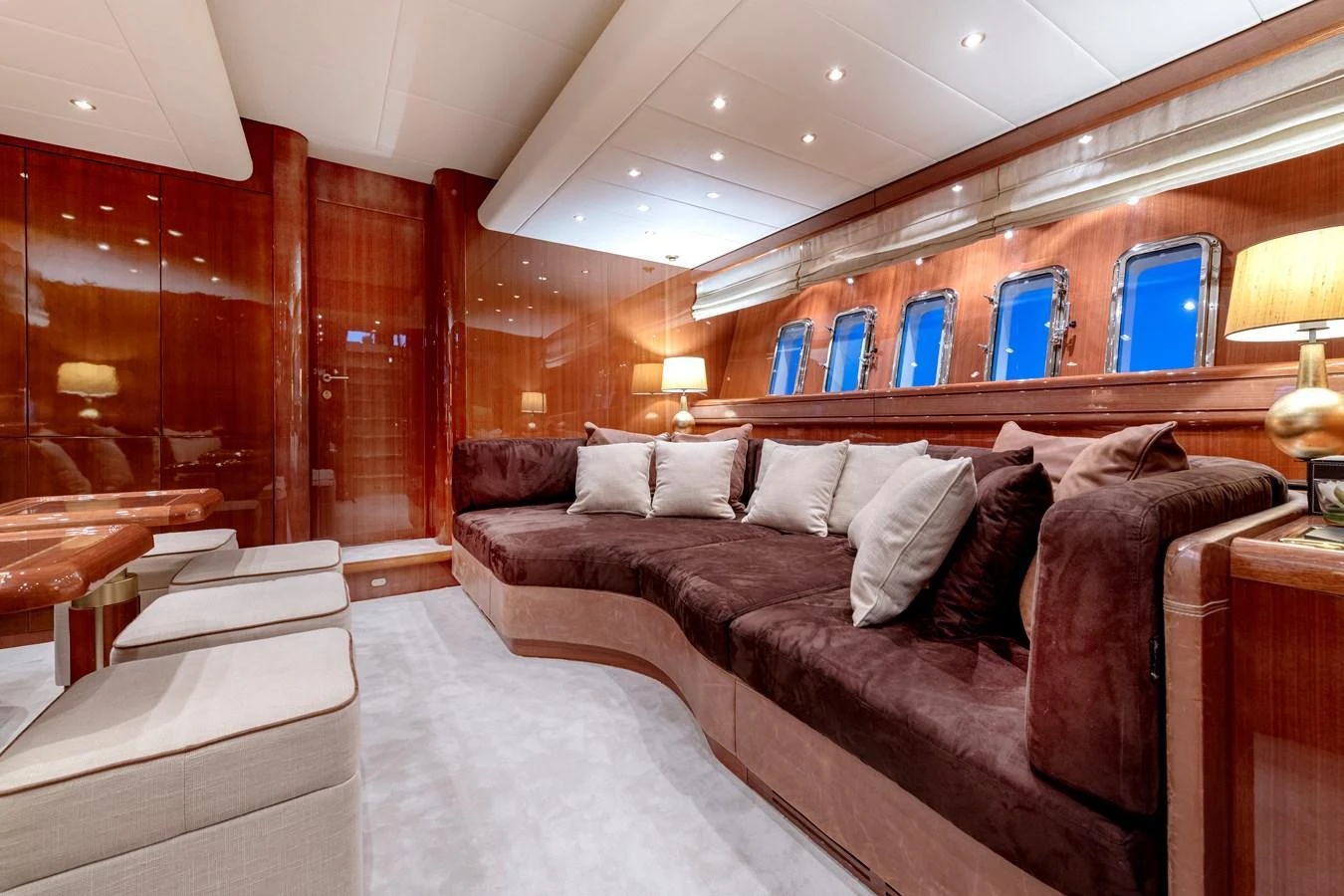 The yacht's salon features luxurious seating with plush cushions and elegant wood paneling, creating a warm and inviting atmosphere. aboard K GRACE Yacht for Sale