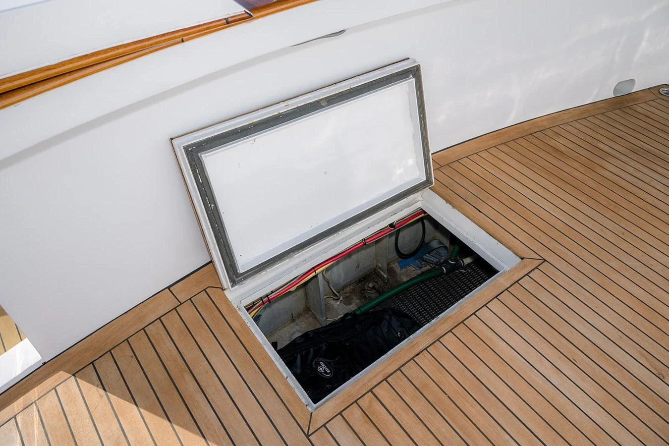 A detailed view of a storage compartment on the yacht's deck, showcasing practical storage solutions. aboard MAMA BEAR Yacht for Sale
