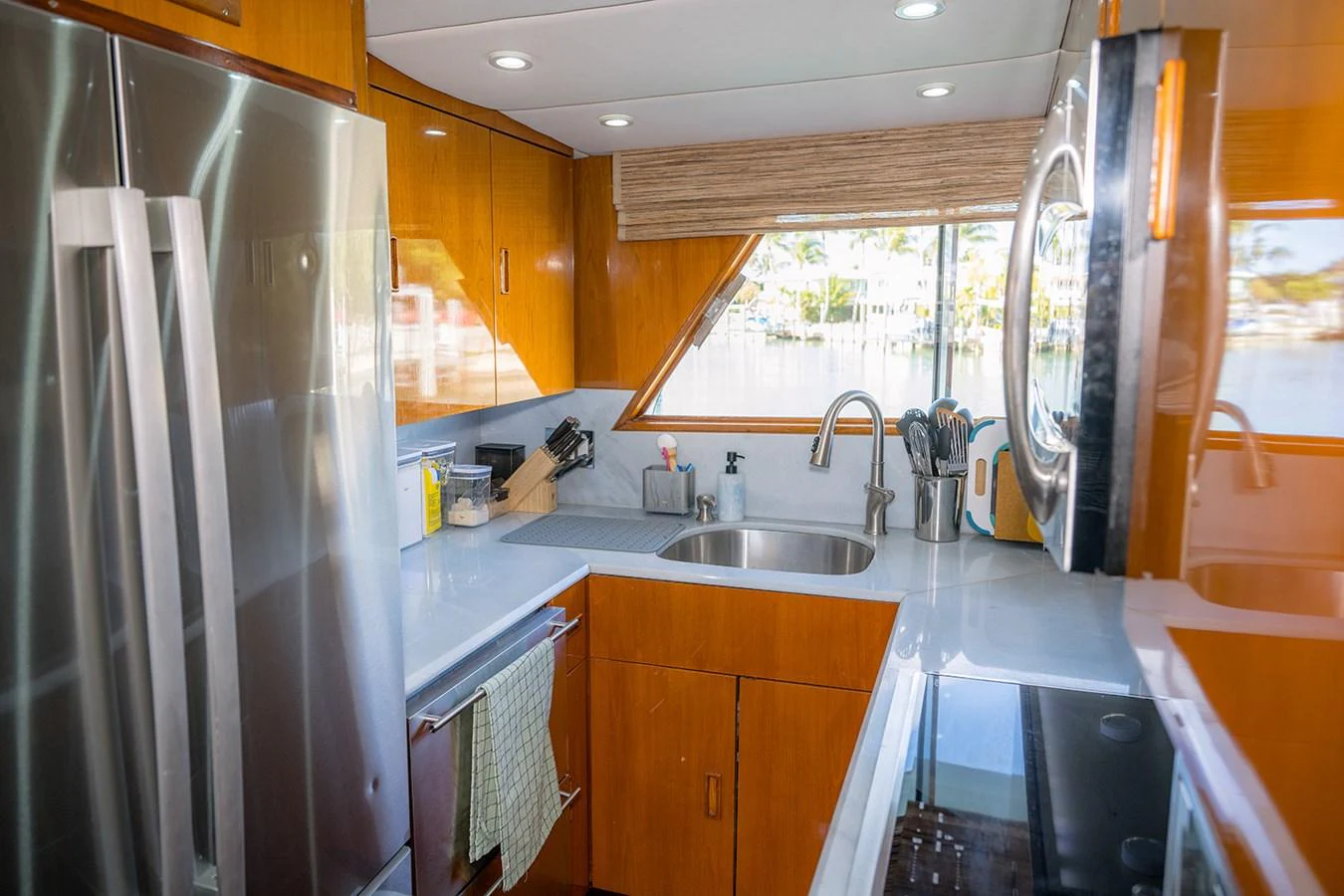 The yacht's galley features modern appliances and ample counter space with a view of the water. aboard MAMA BEAR Yacht for Sale