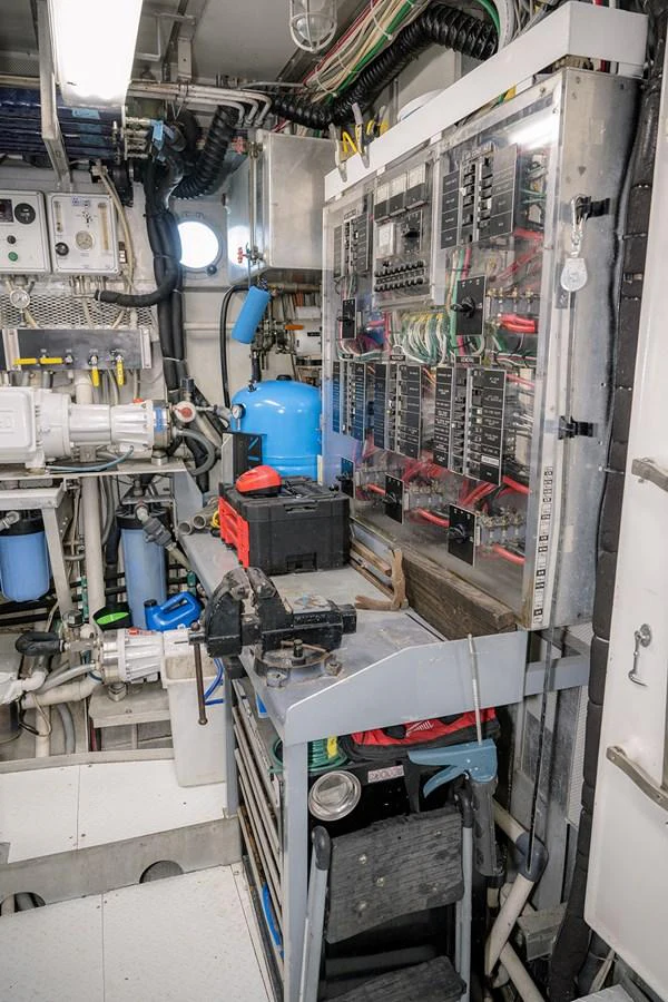 The image showcases the yacht's well-organized engine room with various technical equipment and control panels. aboard MAMA BEAR Yacht for Sale