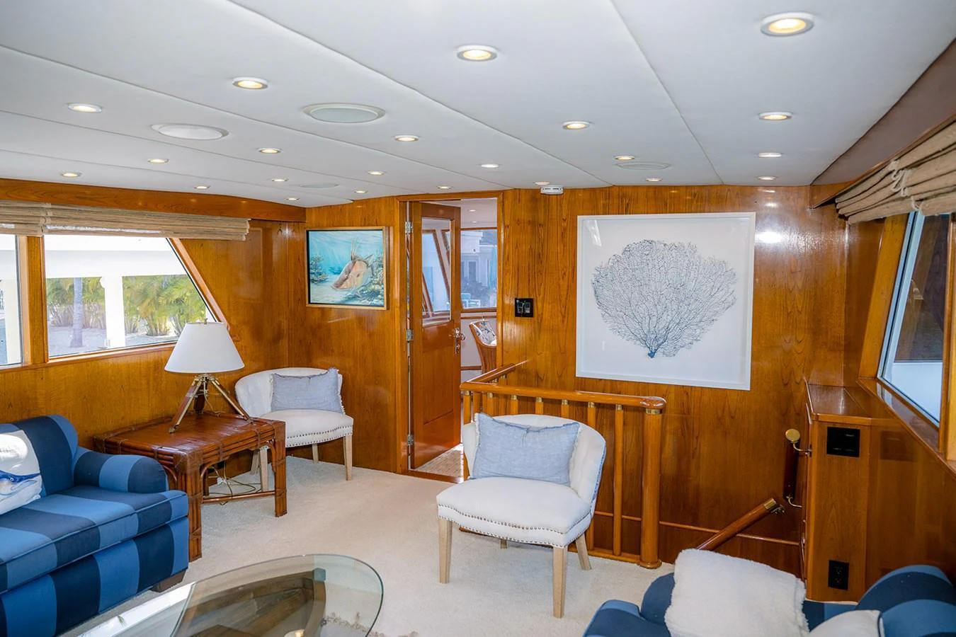 The yacht's interior features a cozy seating area with elegant wooden paneling and tasteful decor. aboard MAMA BEAR Yacht for Sale