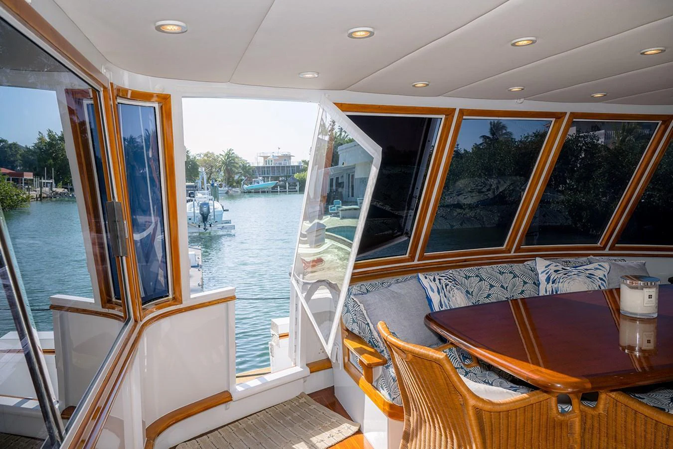 The salon offers a cozy seating area with a view of the water through large windows. aboard MAMA BEAR Yacht for Sale