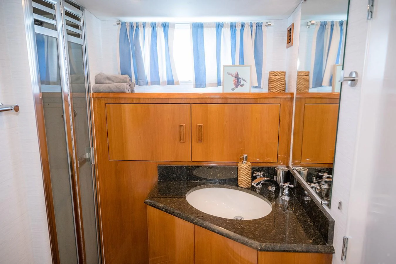 A well-appointed yacht bathroom featuring a sleek sink and ample storage. aboard MAMA BEAR Yacht for Sale