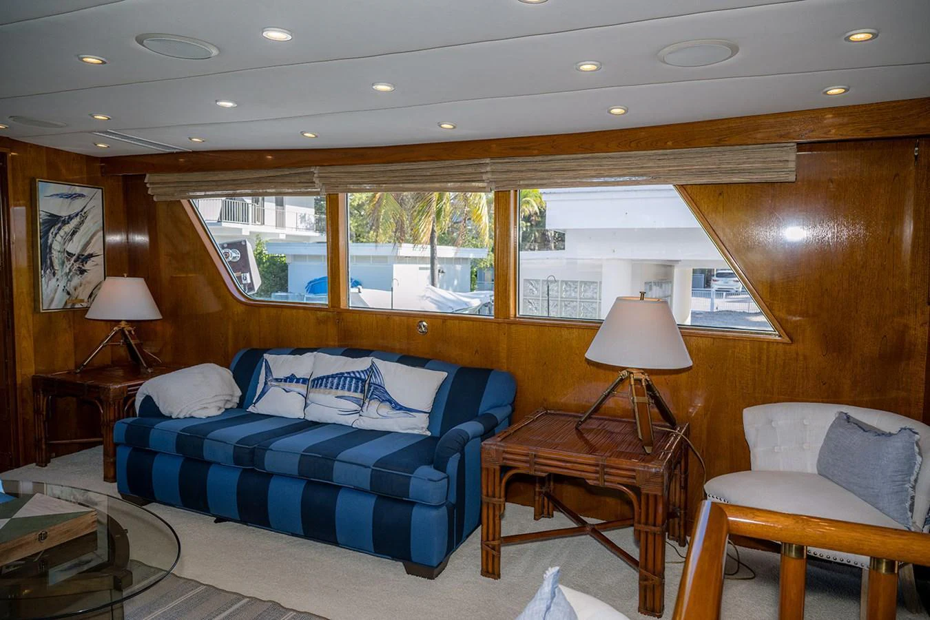 The salon features a comfortable seating area with large windows providing ample natural light. aboard MAMA BEAR Yacht for Sale
