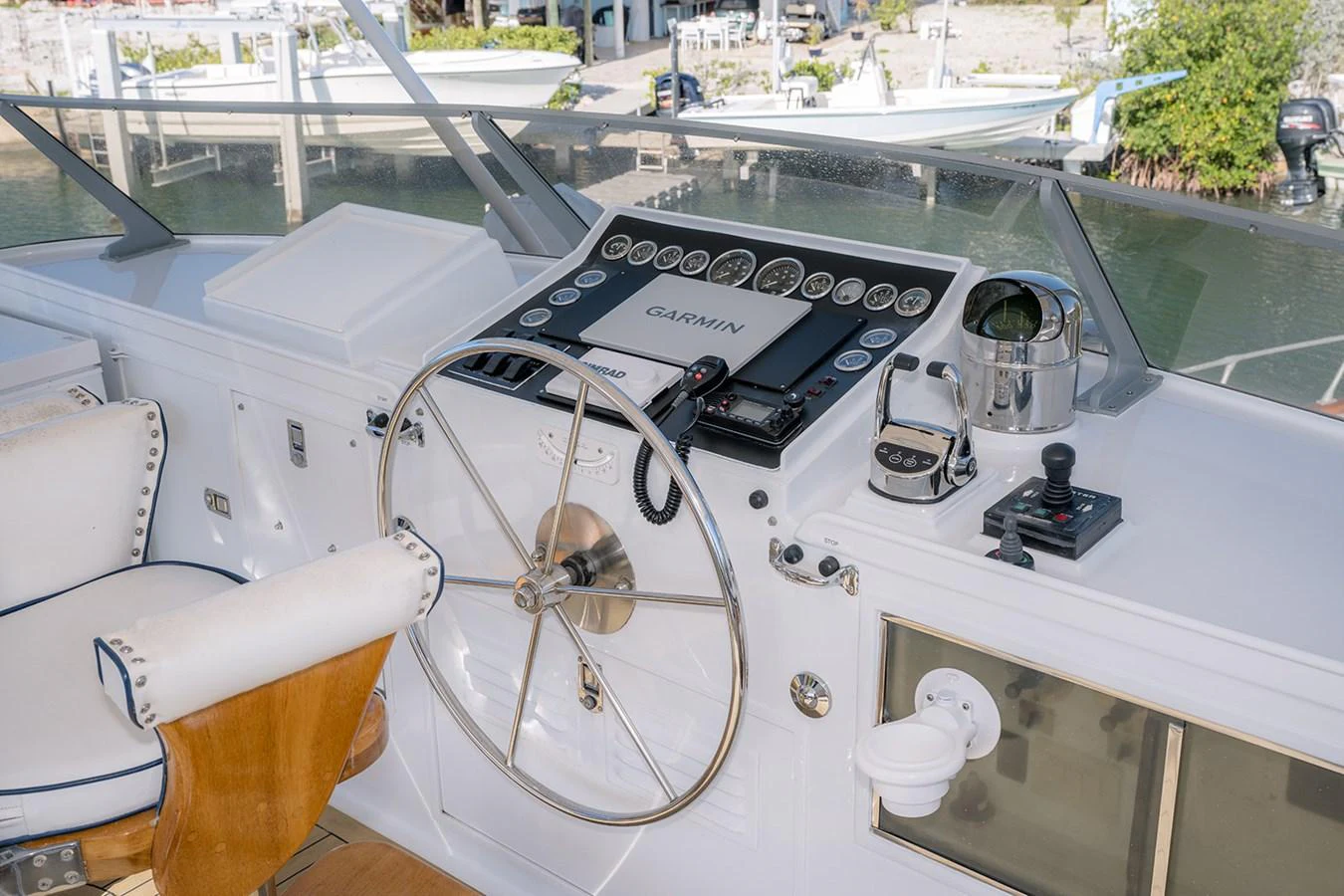 The helm station features modern navigation equipment and a classic steering wheel. aboard MAMA BEAR Yacht for Sale