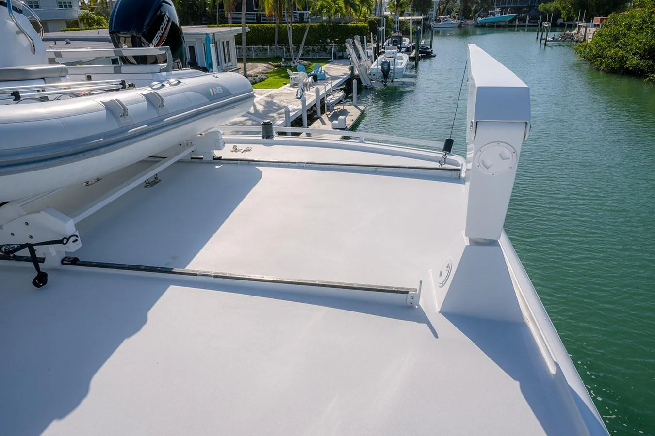 The image shows a detailed view of the yacht's deck with a tender mounted on it. aboard MAMA BEAR Yacht for Sale