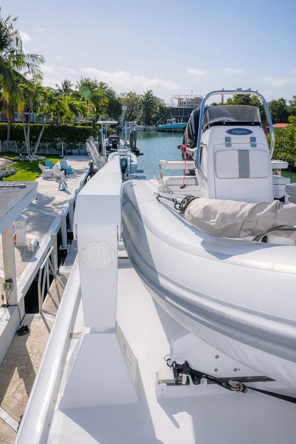 A sleek tender is securely positioned on the yacht's deck, ready for use. aboard MAMA BEAR Yacht for Sale