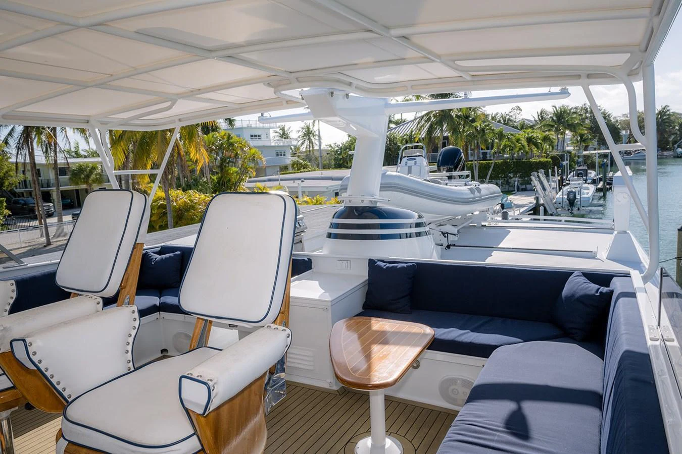 The flybridge offers a spacious and comfortable seating area with a view of the surrounding marina. aboard MAMA BEAR Yacht for Sale
