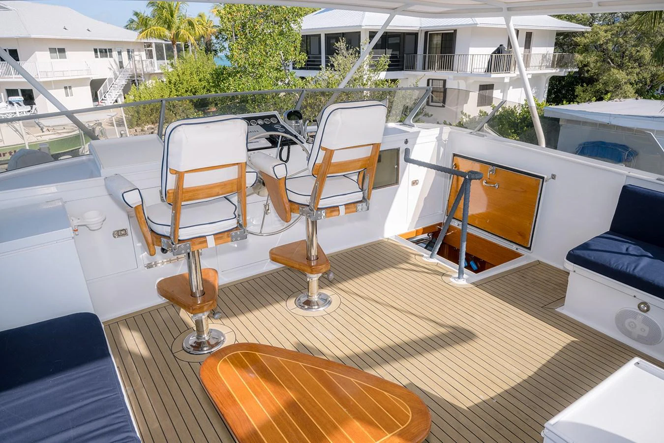 The flybridge features comfortable seating and a well-equipped helm station with a view. aboard MAMA BEAR Yacht for Sale