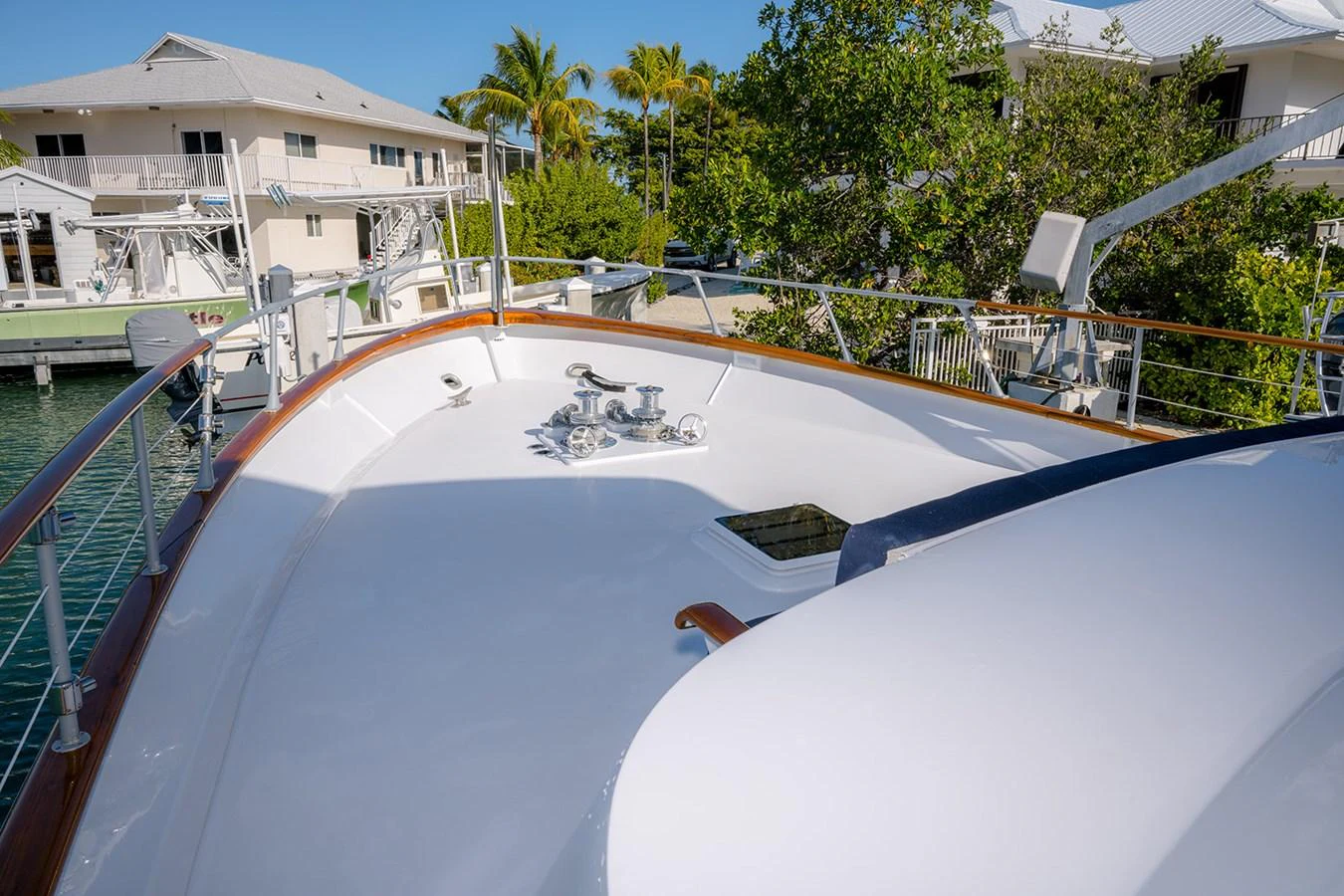 The foredeck of the yacht features a clean, spacious layout with polished railings and a hatch. aboard MAMA BEAR Yacht for Sale