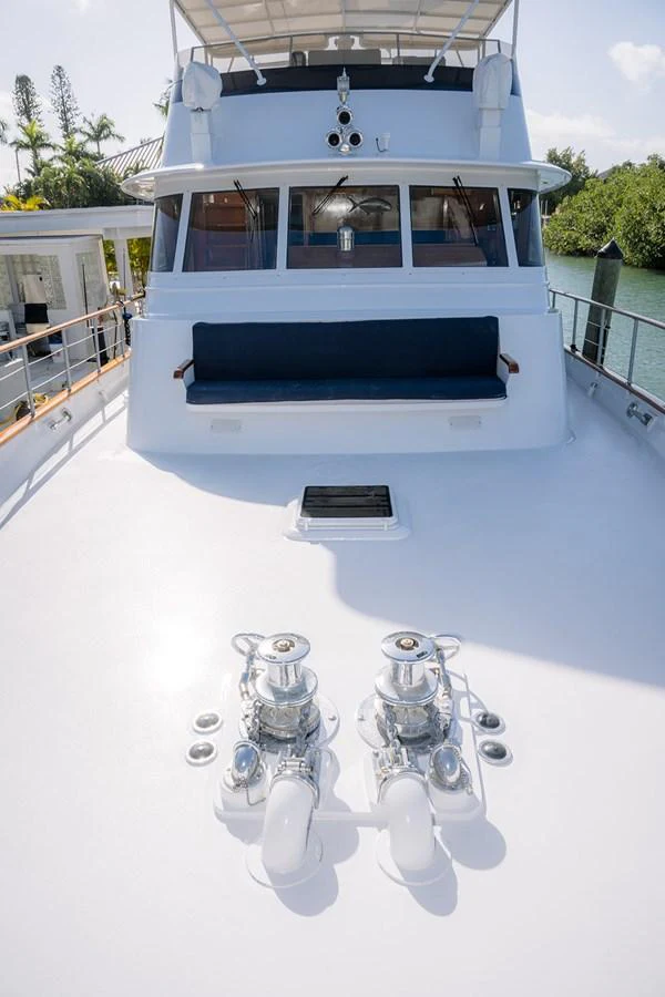 The foredeck features a clean, spacious layout with winches and a comfortable seating area. aboard MAMA BEAR Yacht for Sale
