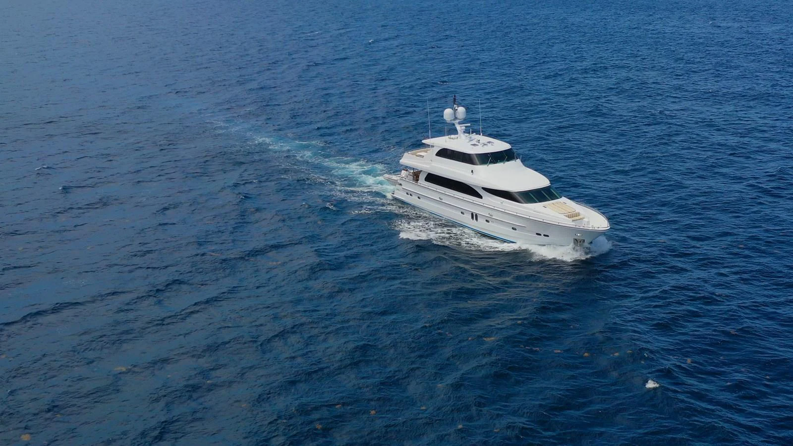A sleek yacht cruises gracefully on the open sea, showcasing its elegant design and luxurious features. aboard PRIME TIME Yacht for Sale