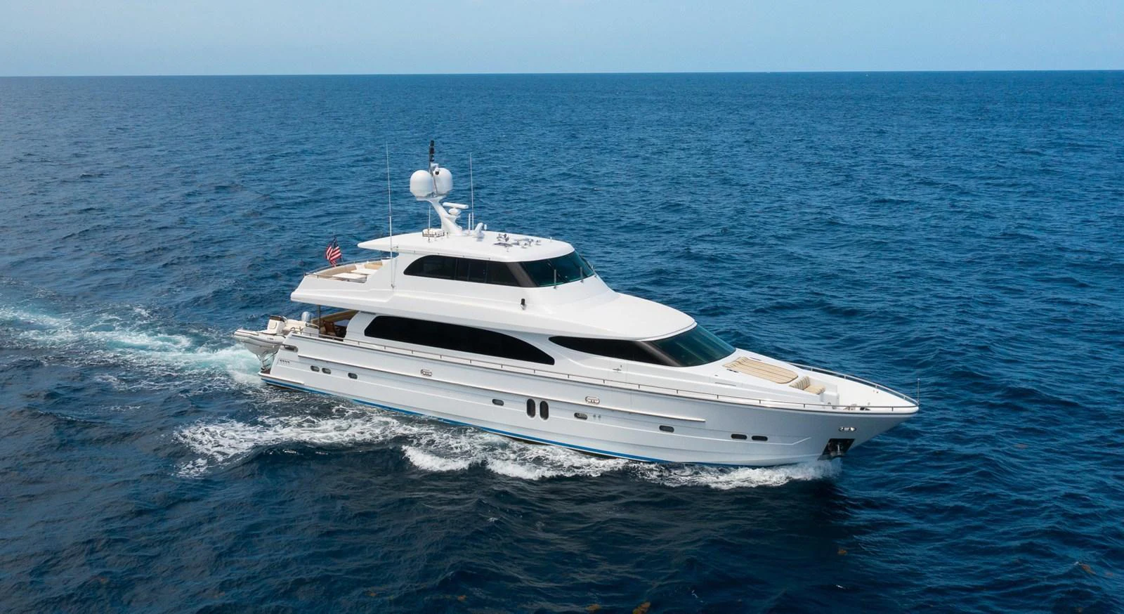 A sleek and elegant yacht cruises through the open sea, showcasing its luxurious design and spacious decks. aboard PRIME TIME Yacht for Sale