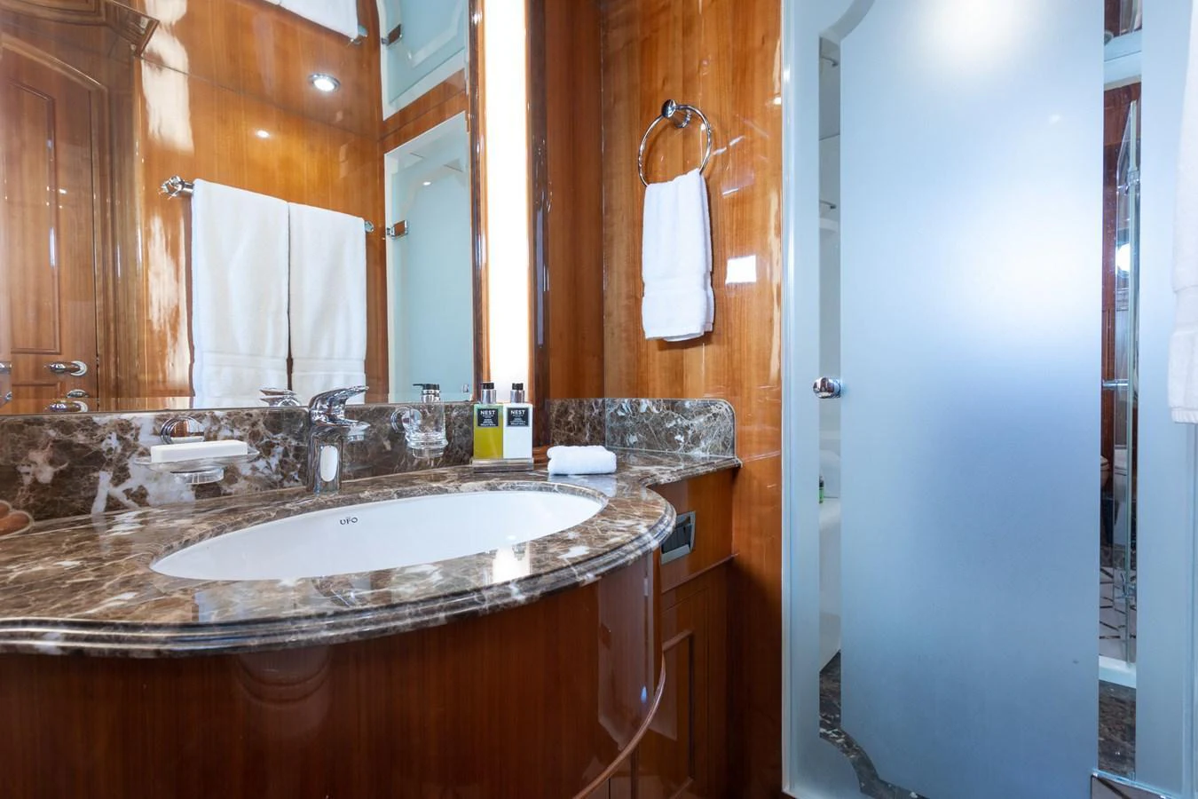 The yacht's bathroom features a luxurious marble countertop and modern fixtures. aboard PRIME TIME Yacht for Sale
