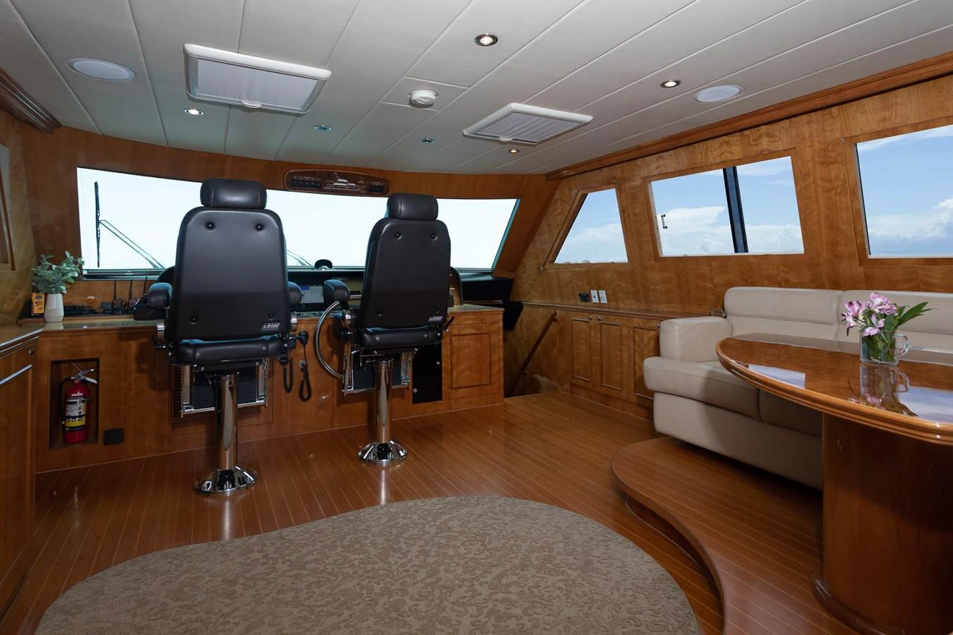 The helm area features comfortable seating and a panoramic view for navigation. aboard PRIME TIME Yacht for Sale