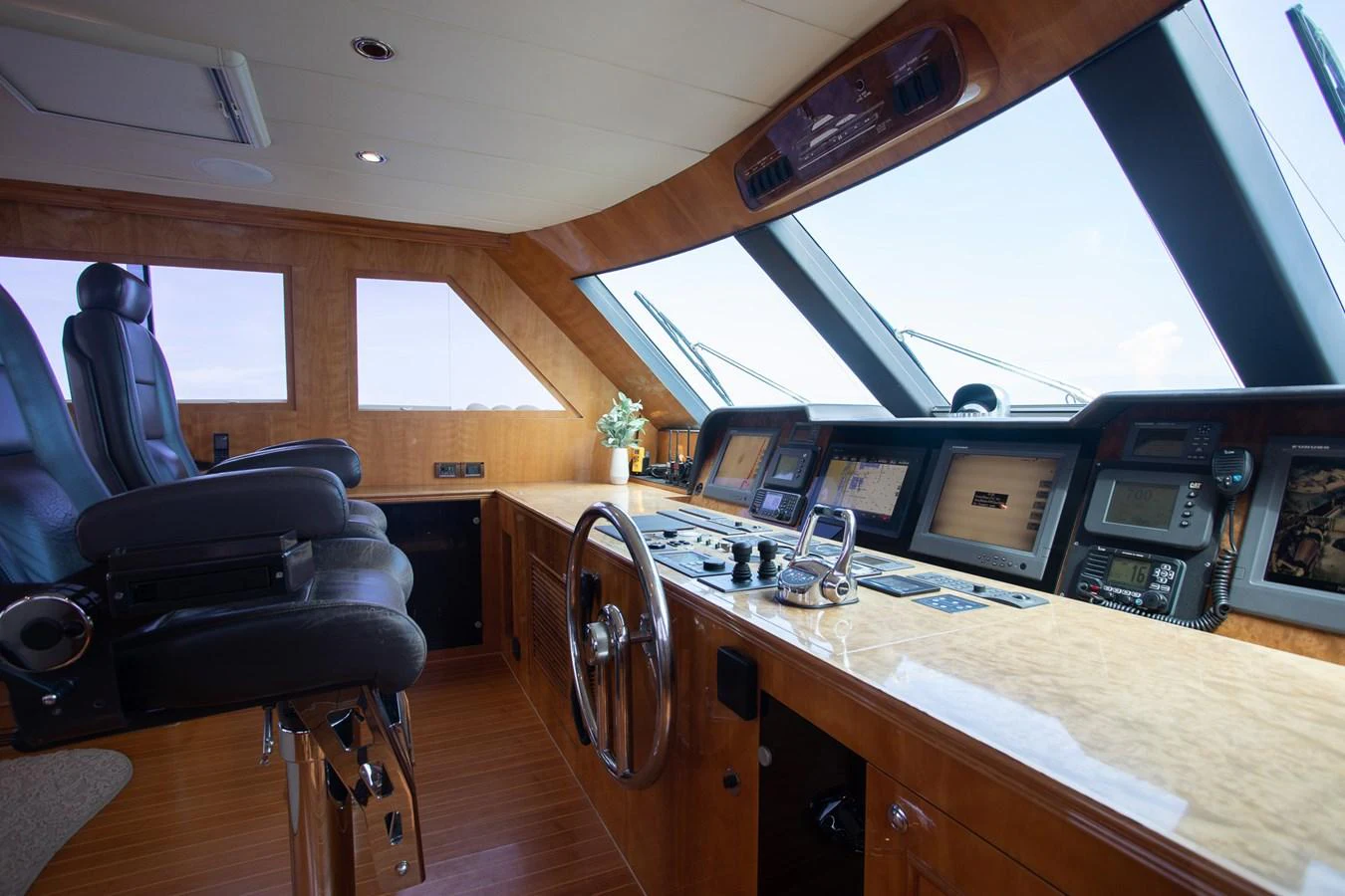The helm station features a sophisticated control panel with panoramic windows offering excellent visibility. aboard PRIME TIME Yacht for Sale