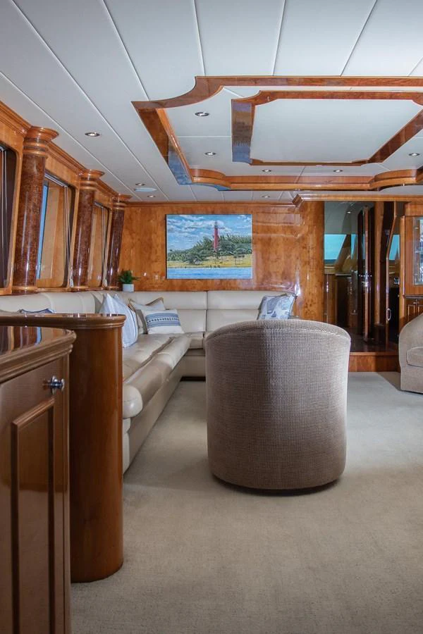 The yacht's interior features a luxurious seating area with elegant wood finishes and plush furnishings. aboard PRIME TIME Yacht for Sale