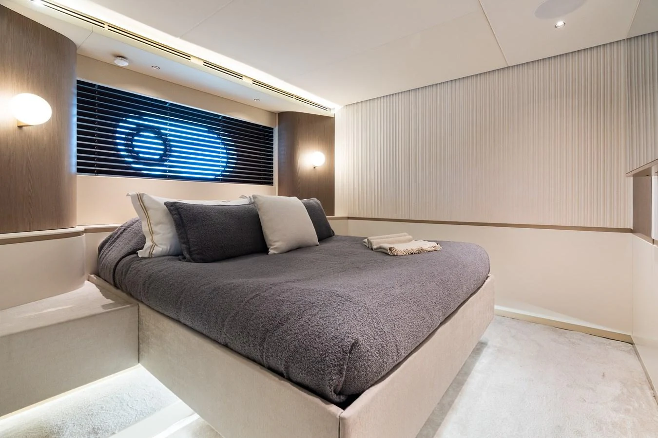 A cozy and modern stateroom with a plush bed and ambient lighting. aboard LIFE Yacht for Sale
