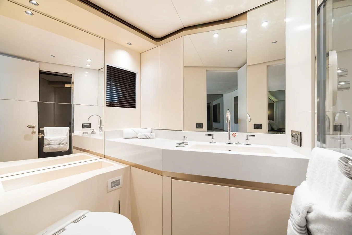 The yacht's bathroom features a sleek, modern design with ample mirrors and clean lines. aboard LIFE Yacht for Sale