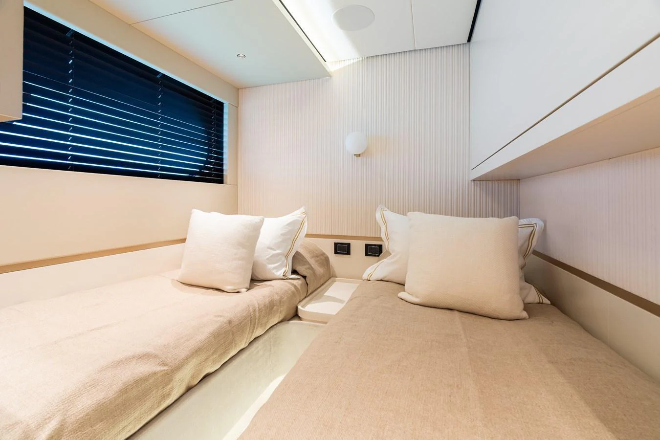 The guest cabin features twin beds with a modern, minimalist design and ample natural light. aboard LIFE Yacht for Sale