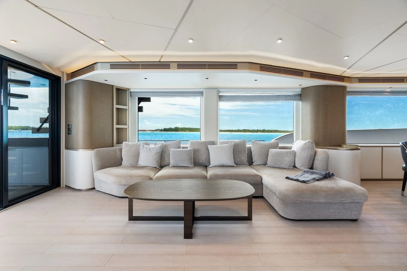 The salon features a spacious and elegant seating area with panoramic windows offering stunning ocean views. aboard LIFE Yacht for Sale