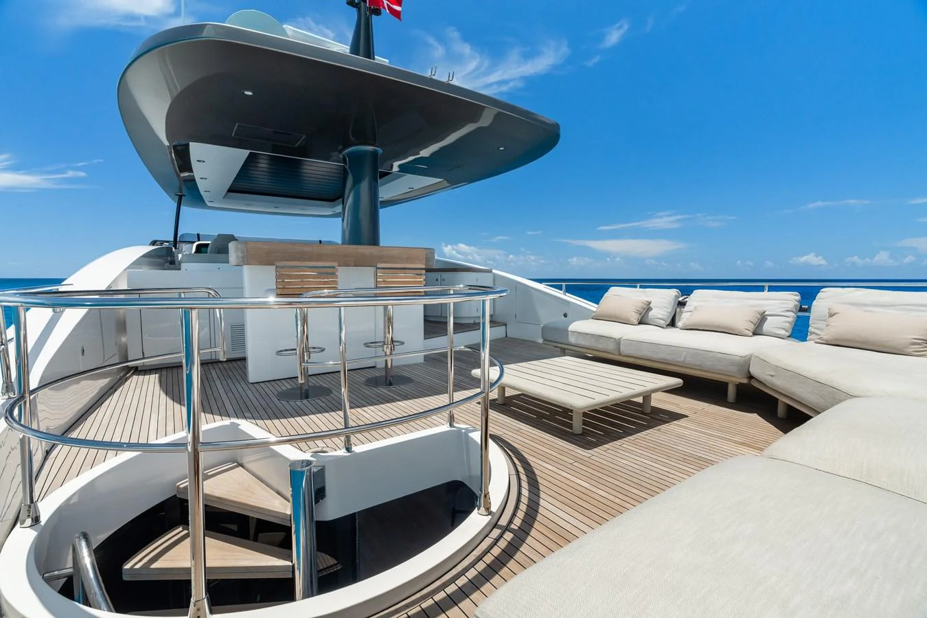 The flybridge offers a spacious and luxurious outdoor lounging area with ample seating and a bar. aboard LIFE Yacht for Sale