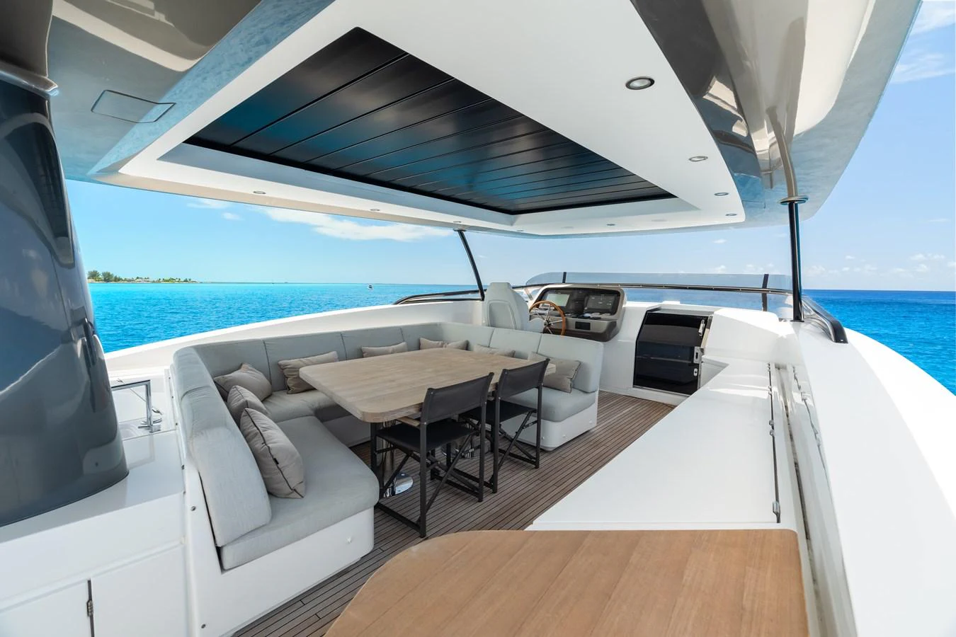 The flybridge offers a spacious and luxurious outdoor seating area with stunning ocean views. aboard LIFE Yacht for Sale