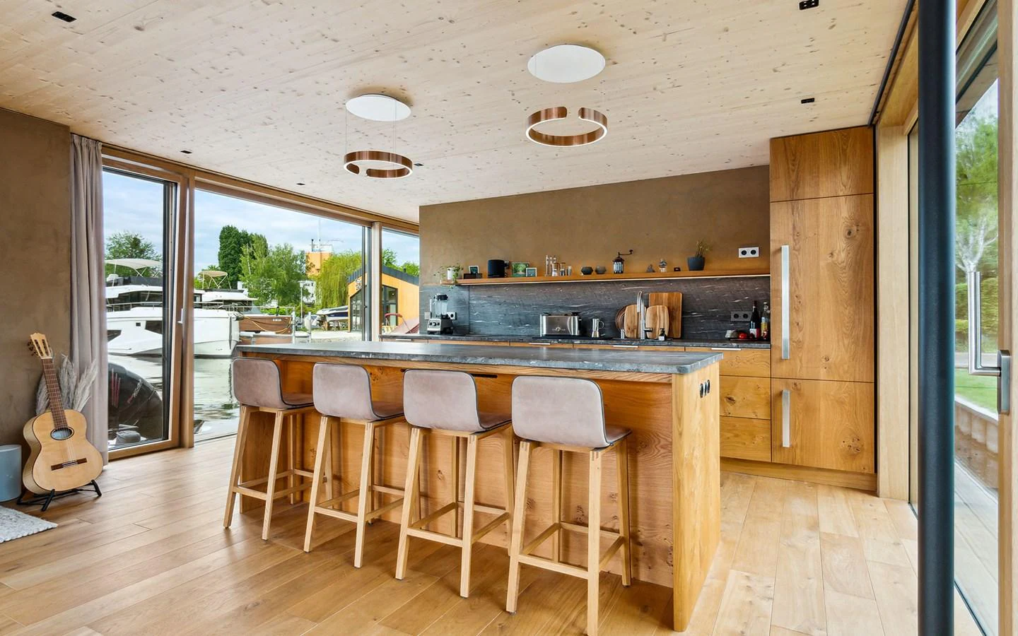 A modern galley with wooden accents and ample seating. aboard OHANA Yacht for Sale