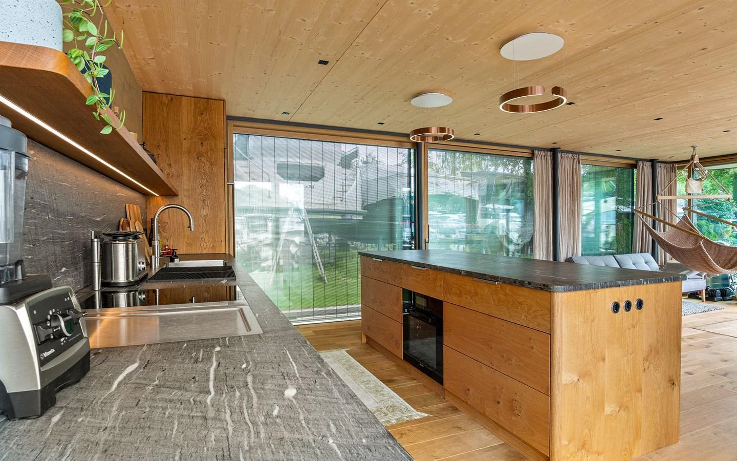 The yacht's galley features modern appliances, a sleek countertop, and ample natural light. aboard OHANA Yacht for Sale
