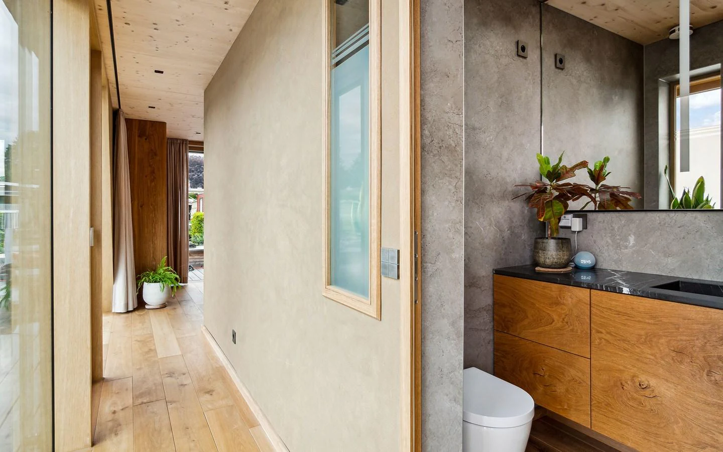 The yacht's interior features a modern hallway with wooden accents and a sleek bathroom. aboard OHANA Yacht for Sale