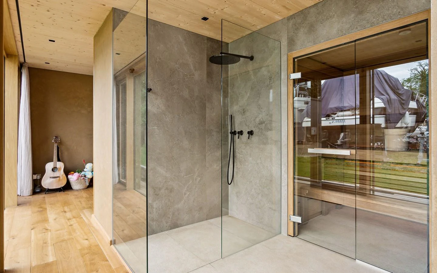 The yacht's bathroom features a modern glass shower and a view of the exterior. aboard OHANA Yacht for Sale