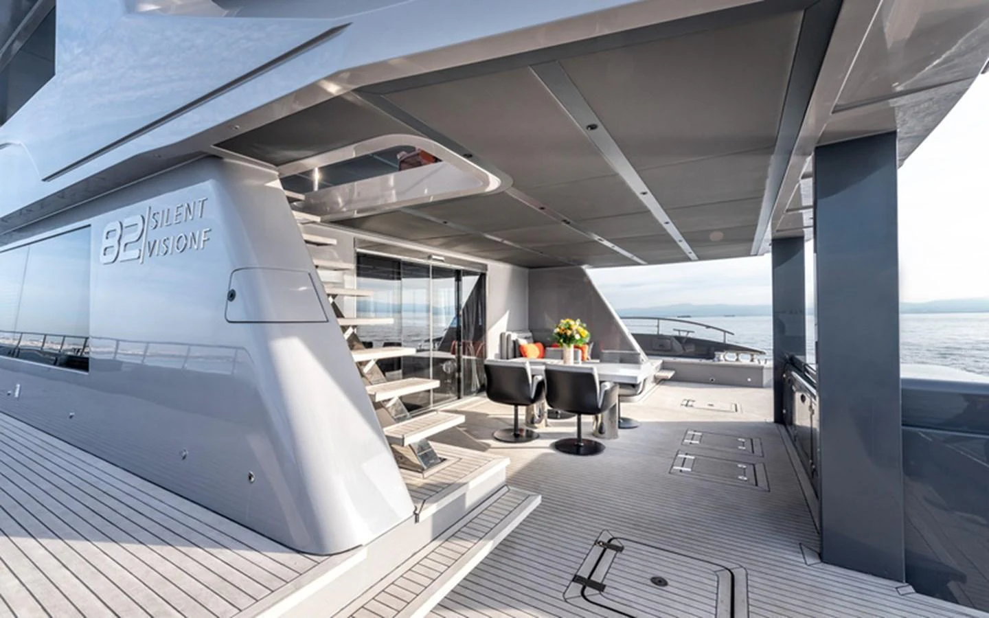 The aft deck features a stylish and spacious outdoor seating area with modern furnishings and a sleek design. aboard SITARA Yacht for Sale