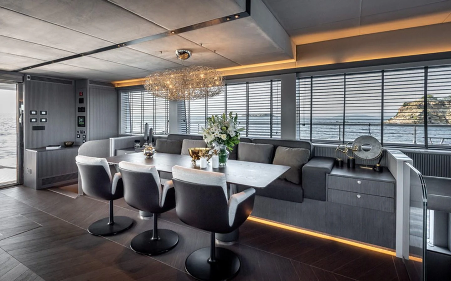 The yacht's dining area features a modern design with a large table, comfortable chairs, and panoramic windows offering stunning sea views. aboard SITARA Yacht for Sale
