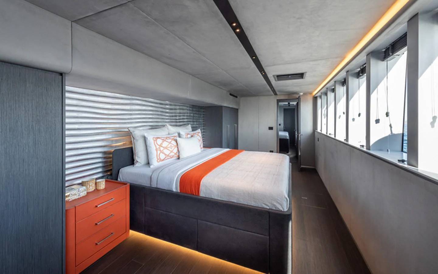A modern stateroom featuring a large bed with stylish bedding and ample natural light from side windows. aboard SITARA Yacht for Sale