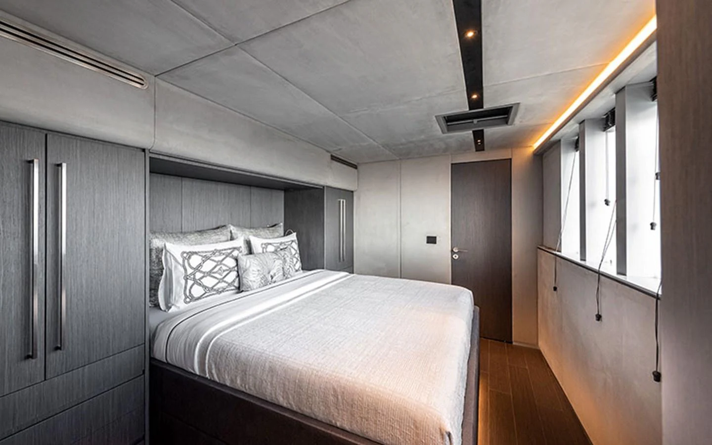 The stateroom features a modern design with sleek cabinetry and large windows for natural light. aboard SITARA Yacht for Sale