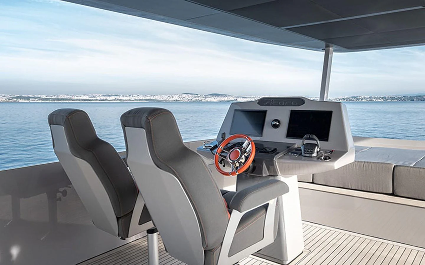 The helm station features modern controls and comfortable seating with a panoramic view of the sea. aboard SITARA Yacht for Sale