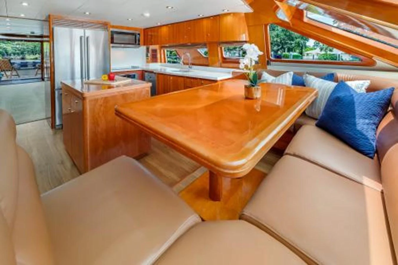 The yacht's galley features a spacious dining area with plush seating and a well-equipped kitchen. aboard SUE CAROLYN Yacht for Sale